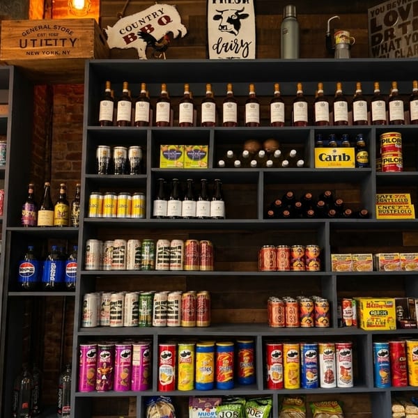 Shelves filled with various food and beverage products, including canned goods, bottles, and snacks.